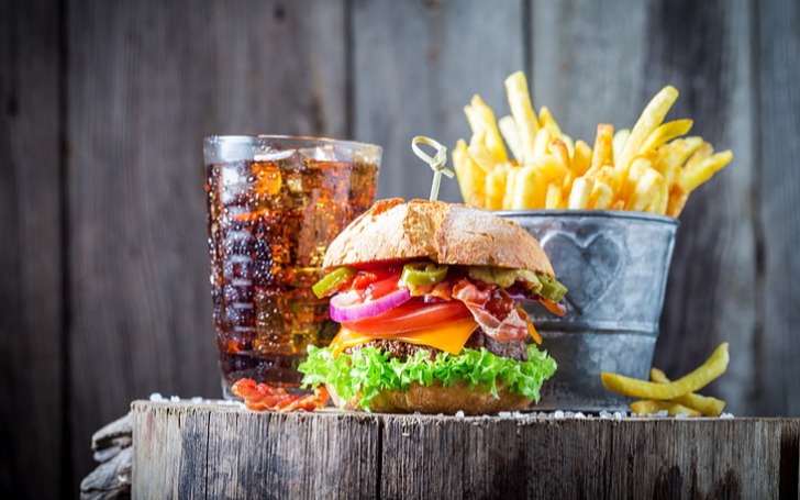 Plate of burger and fries with a soft drink